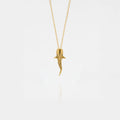 Whale-shark gold pendant on a white background