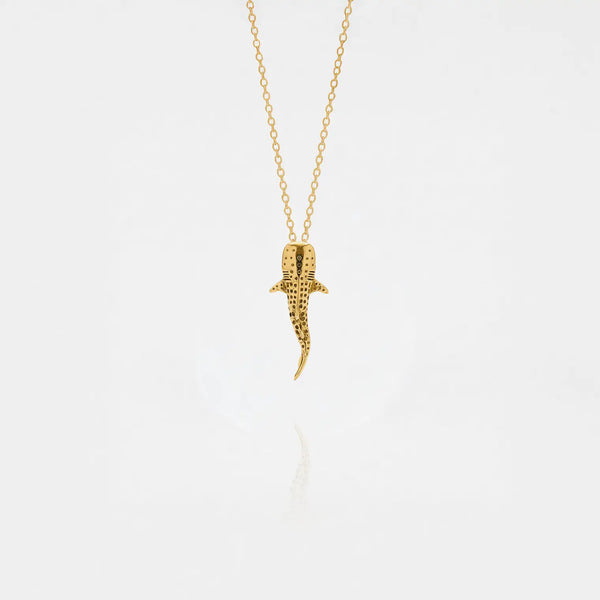 Whale-shark gold pendant on a white background