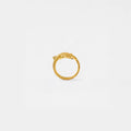 Gold whale-shark ring on a light gray background