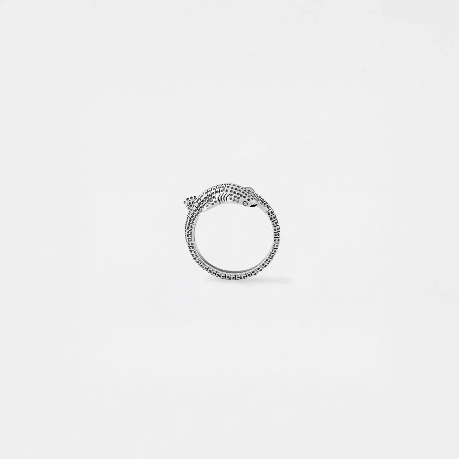 Silver whale-shark ring with on a light gray background