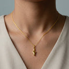 woman wearing white-shark gold pendant 