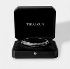 Silver bracelet in a black Tikalkun jewelry box on a light gray background
