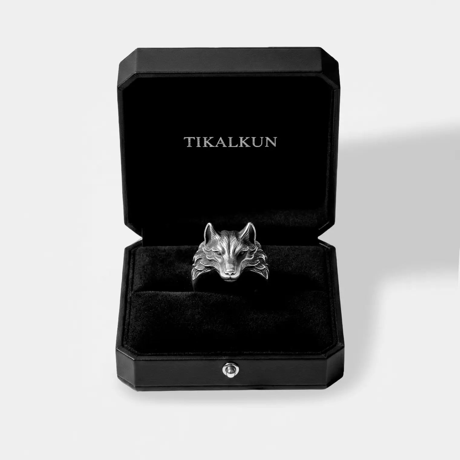 Silver wolf-shaped ring in a black Tikalkun box on a light gray background