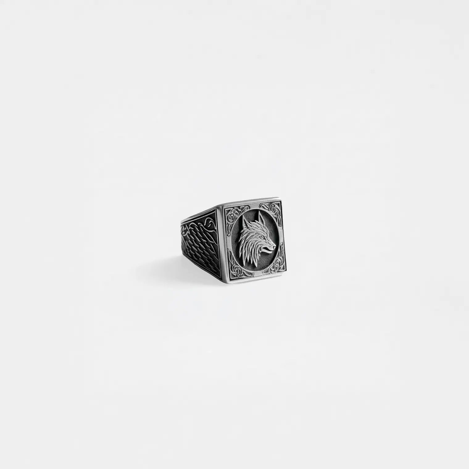 Silver ring with a wolf design on a light gray background
