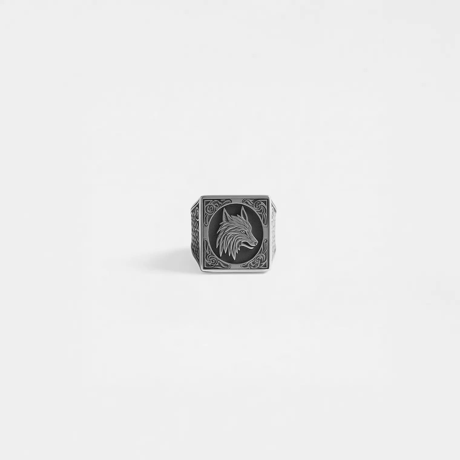 Silver ring with wolf design on a light gray background