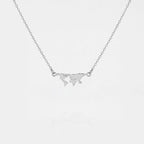 Silver necklace with a world map pendant on a light gray background
