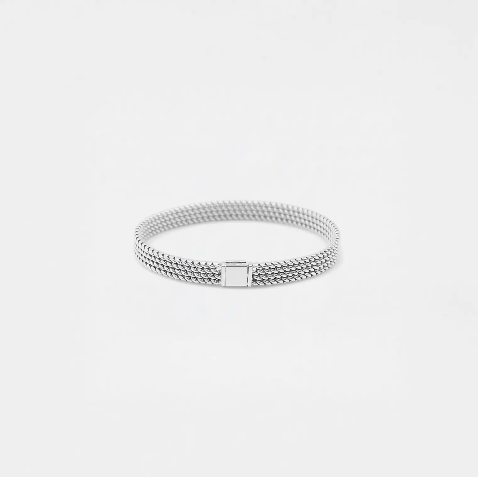 Silver bracelet on a light gray background