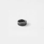 Silver ring with a textured pattern on a white background