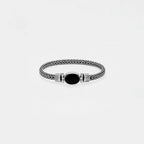 Bracelet with braided design and black oval stone on a light gray background