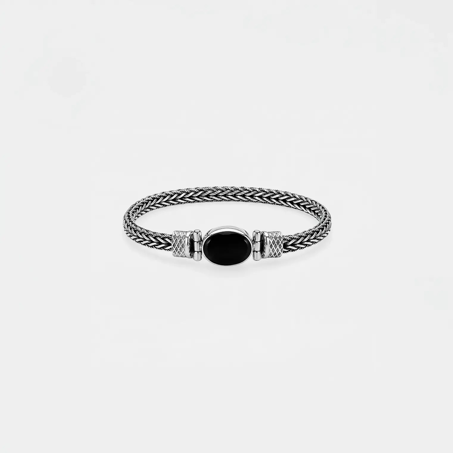 Bracelet with braided design and black oval stone on a light gray background