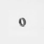 Silver ring with woven design on a light gray background