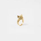 Gold cat ring with sparkling stones on a white background