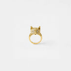 Gold cat ring with sparkling stones on a white background