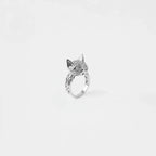 Silver cat ring with sparkling stones on a white background
