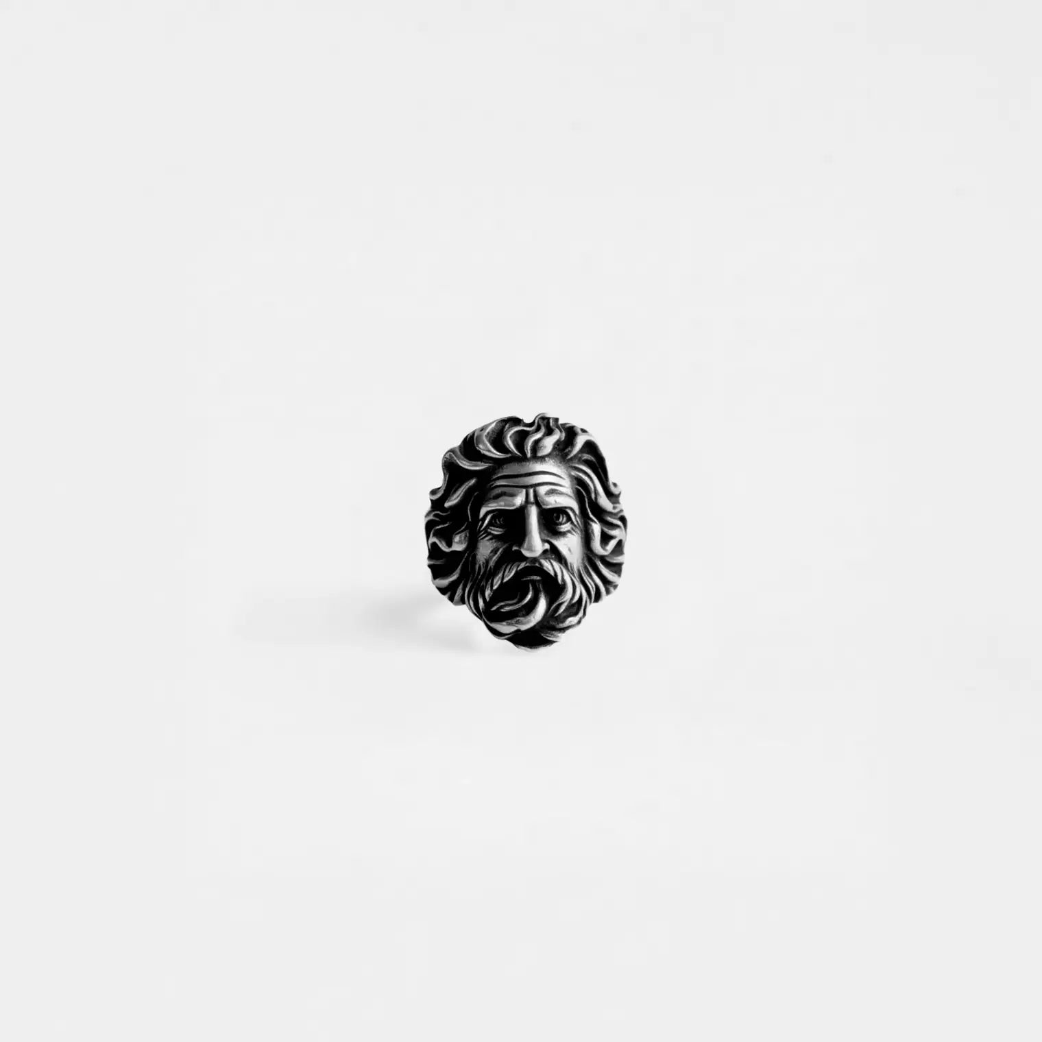 Silver zeus head ring on a white background