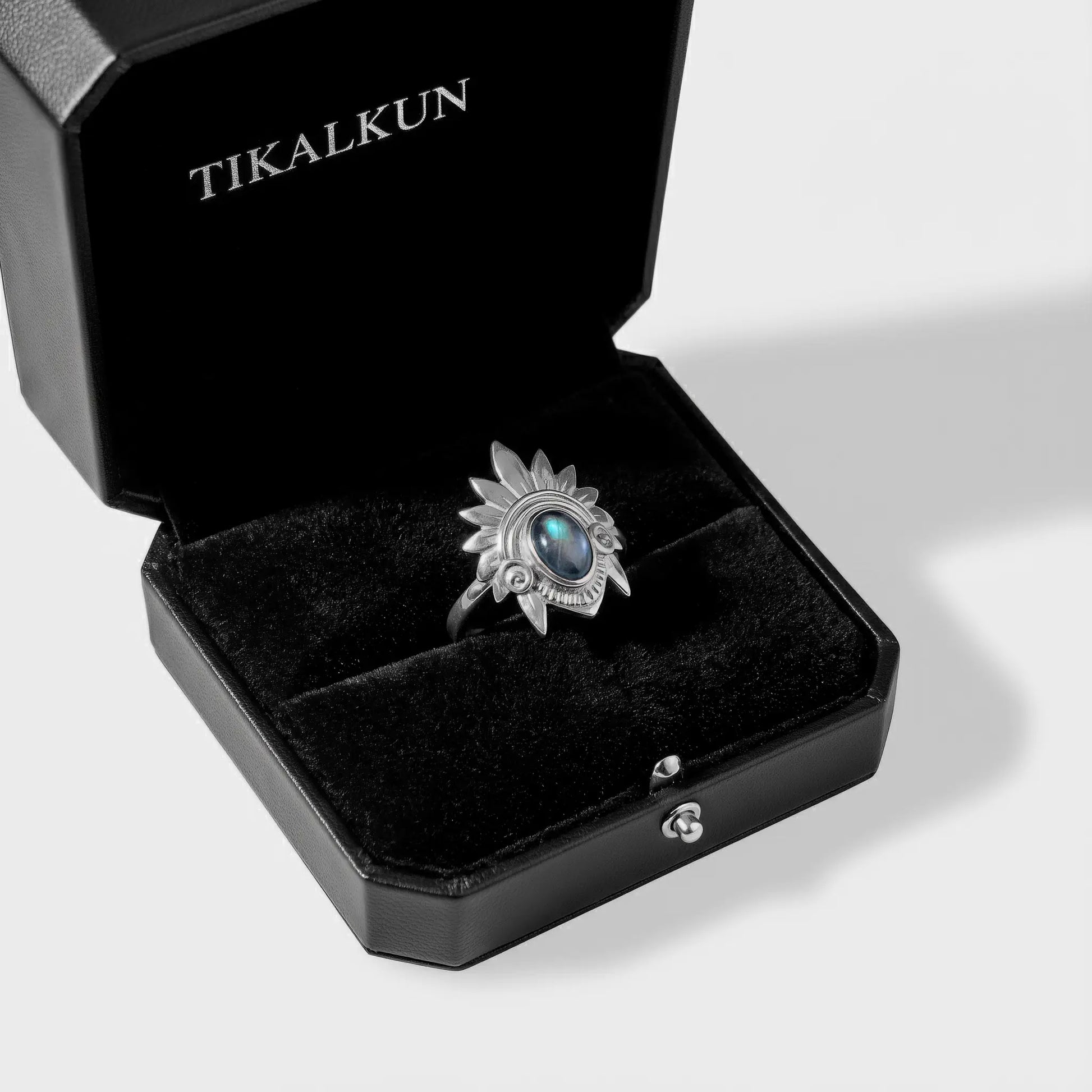 aztec headdress Silver ring with a blue gemstone in a black Tikalkun jewelry box on a white background