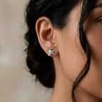 Close-up of a woman wearing a silver turtle earring