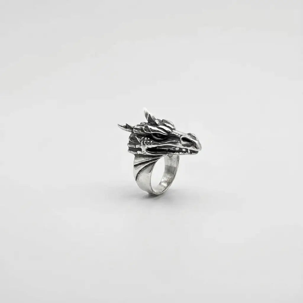 Silver dragon head ring on a white background