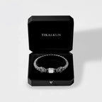 feathered serpent silver bracelet in a black Tikalkun box on a light gray background