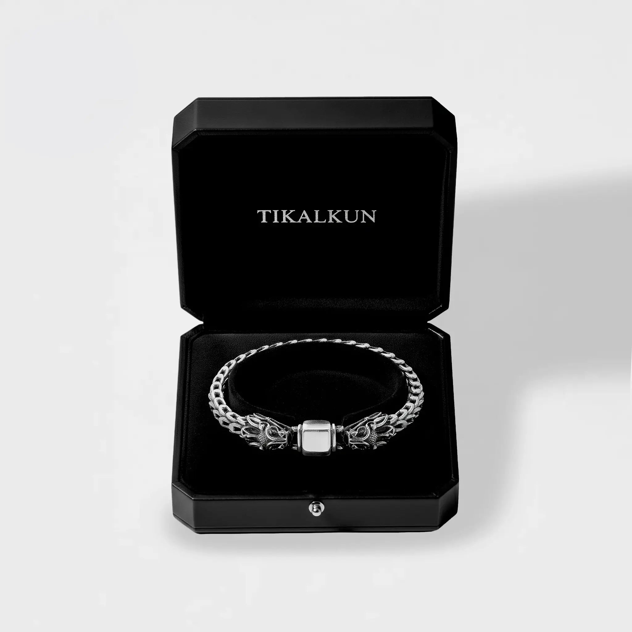 feathered serpent silver bracelet in a black Tikalkun box on a light gray background