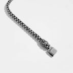 Silver bracelet with quetzalcoatl, the feathered serpent design on a light gray background