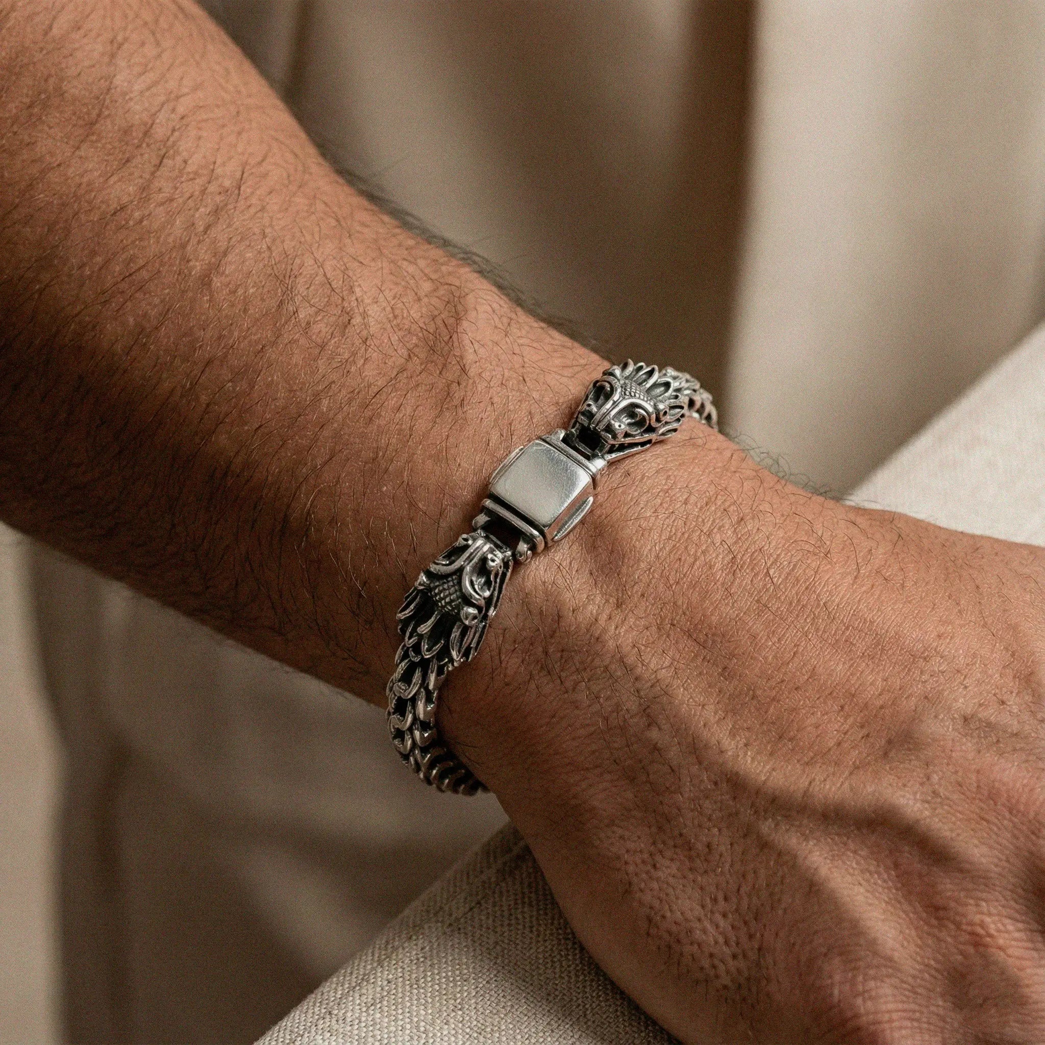man wearing Silver bracelet with quetzalcoatl, the feathered serpent design