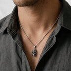 man weating a jaguar-warrior silver pendant 