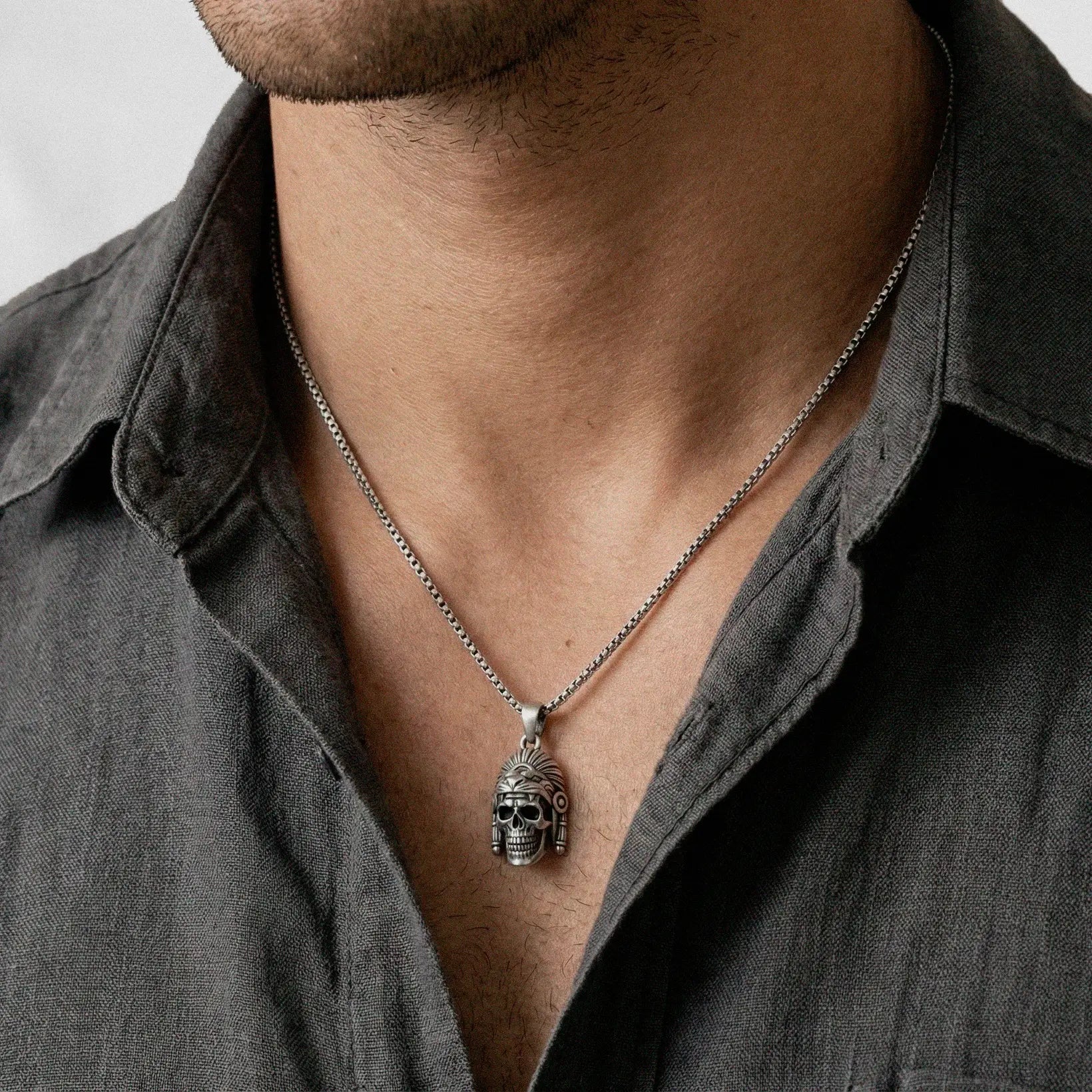 man weating a jaguar-warrior silver pendant 