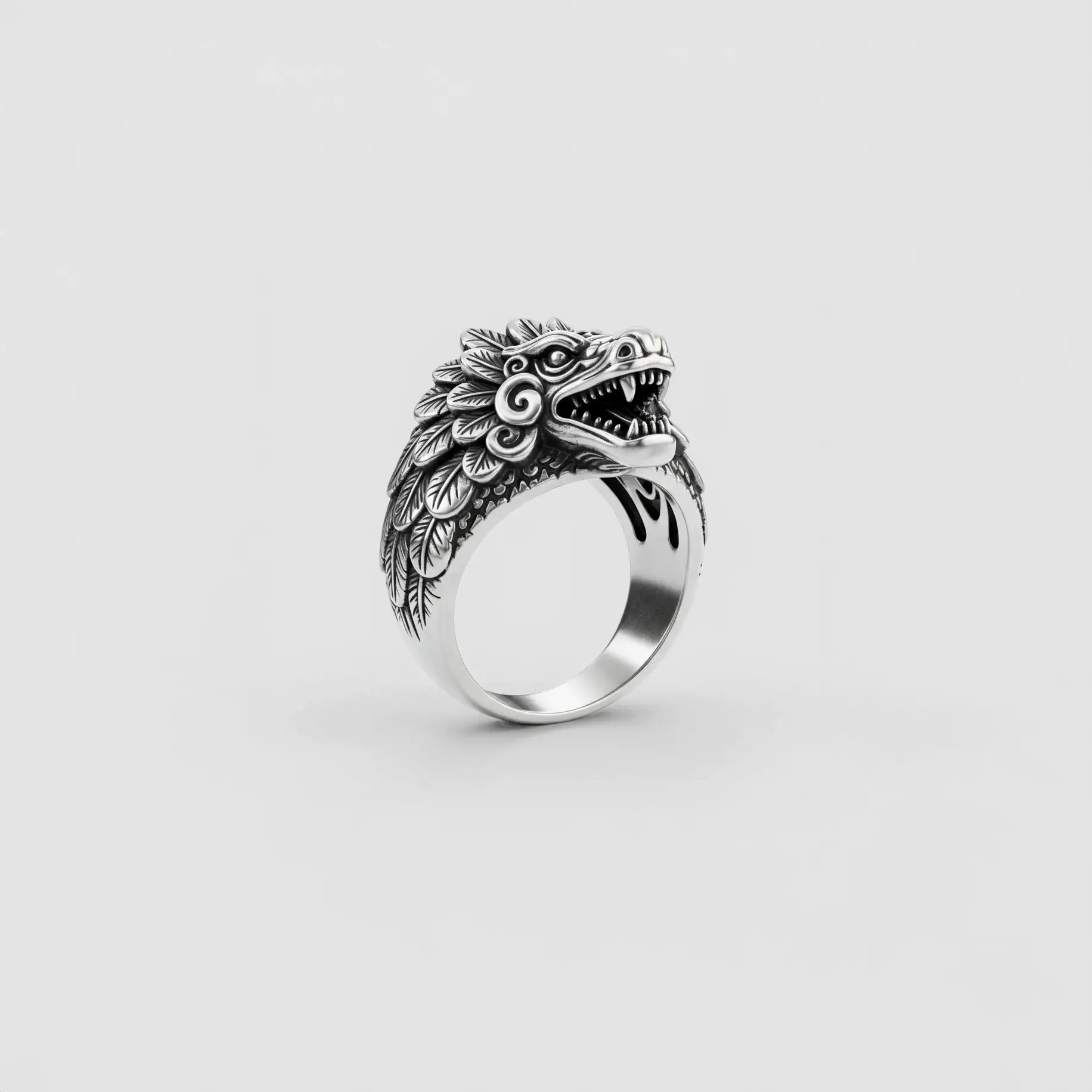 Silver ring with kukulkan design on a light gray background