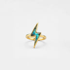 Gold lightning bolt ring with labradorite gemstone on a light gray background