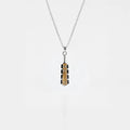 Necklace with a macahuitl pendant on a light gray background, aztec sword pendant