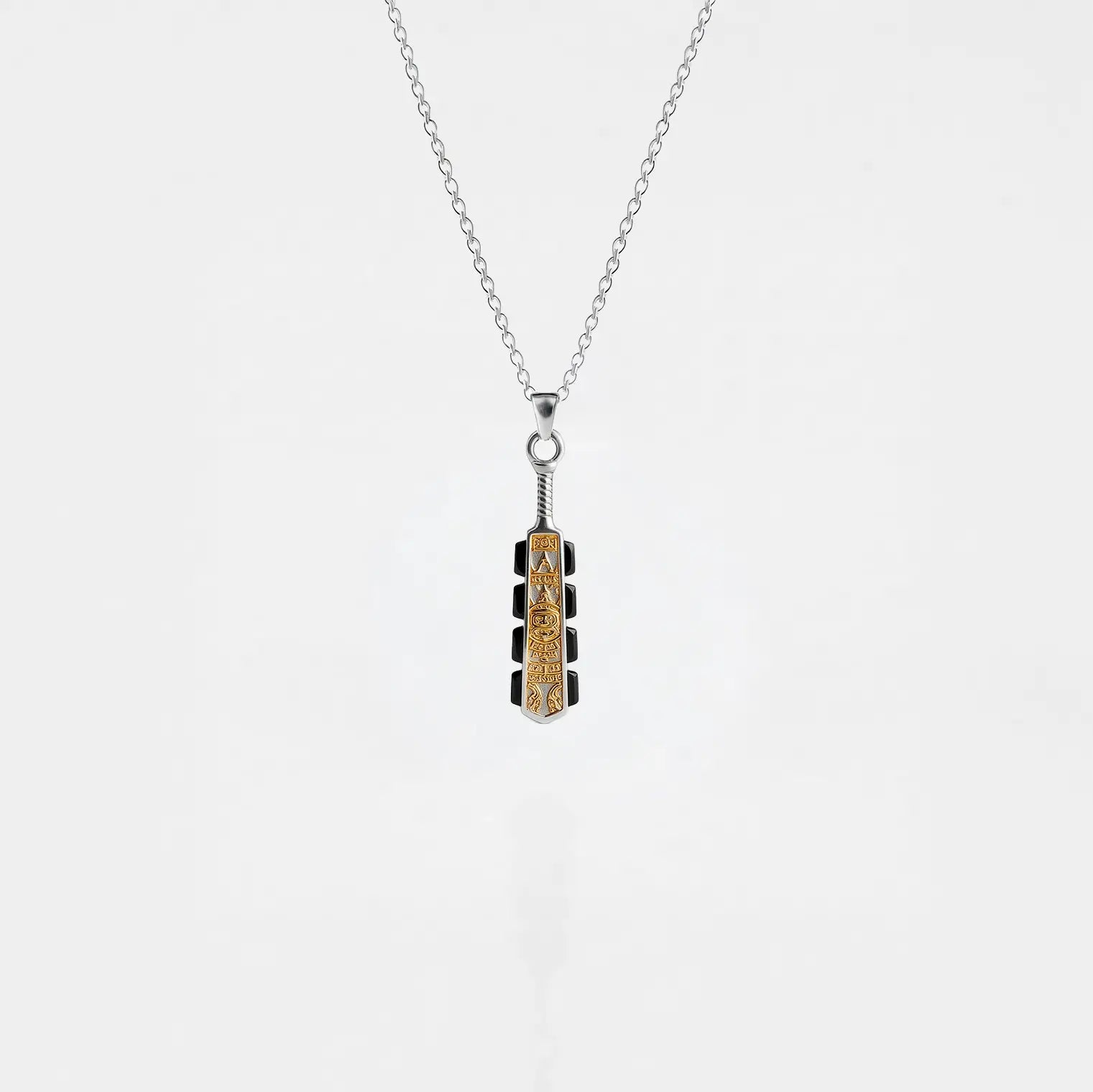Necklace with a macahuitl pendant on a light gray background, aztec sword pendant