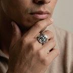 man wearing a mayan mask silver ring 