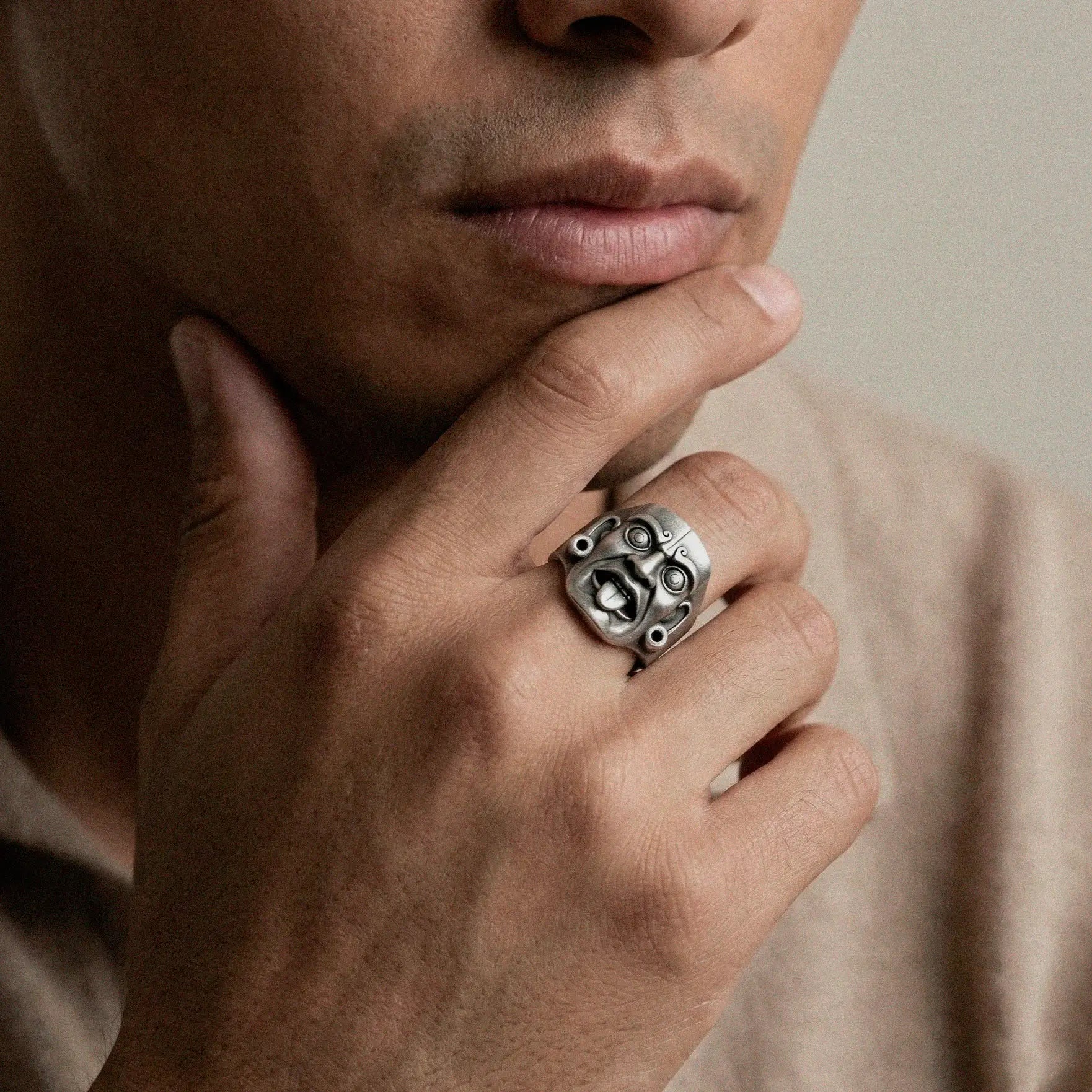 man wearing a mayan mask silver ring 