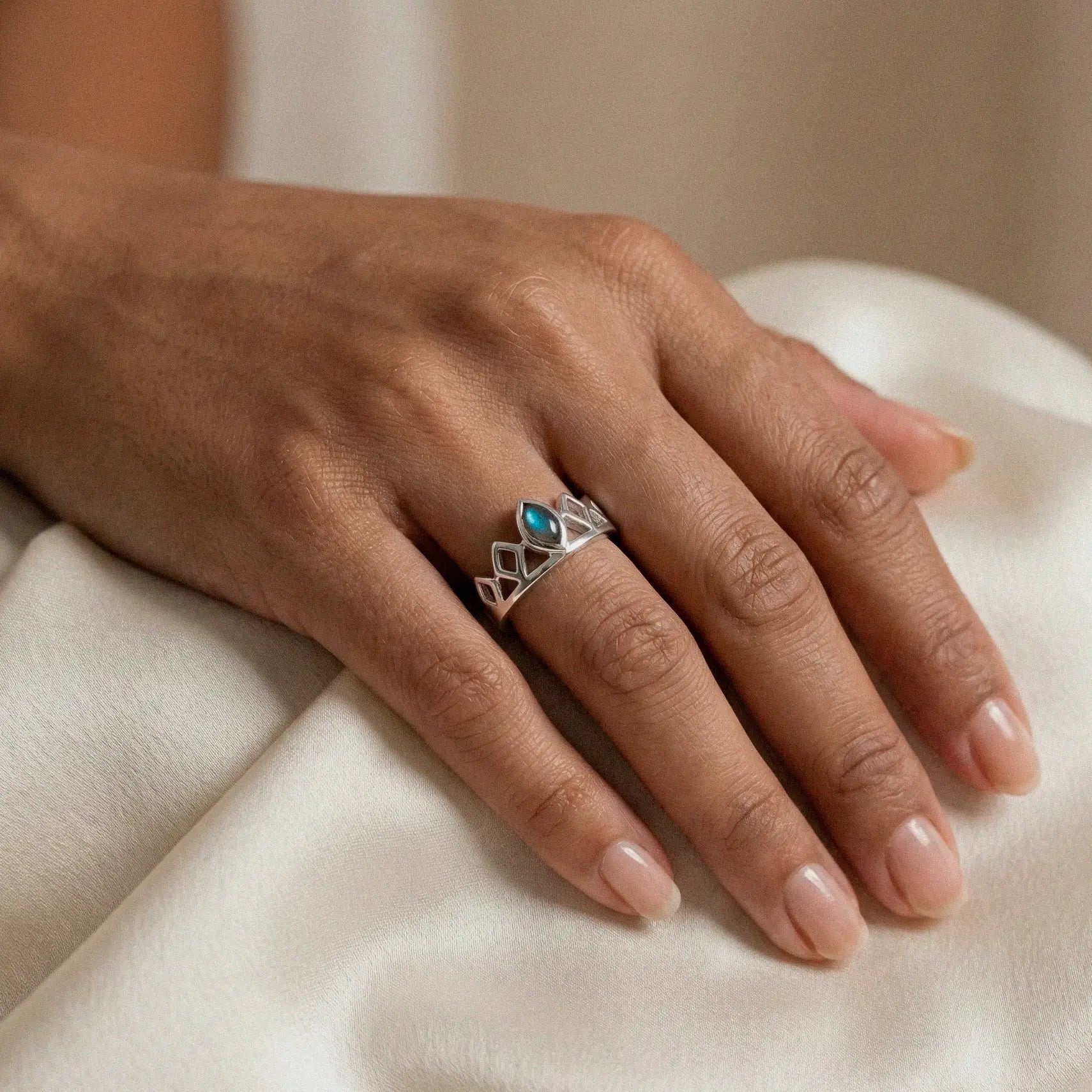 woman's hand wearing mayan princess silver ring with labradorite stone