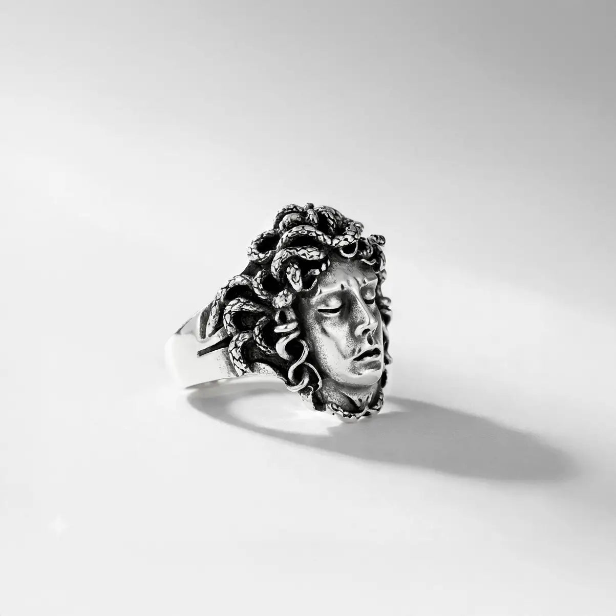 handcrafted medusa silver ring for men on a white background