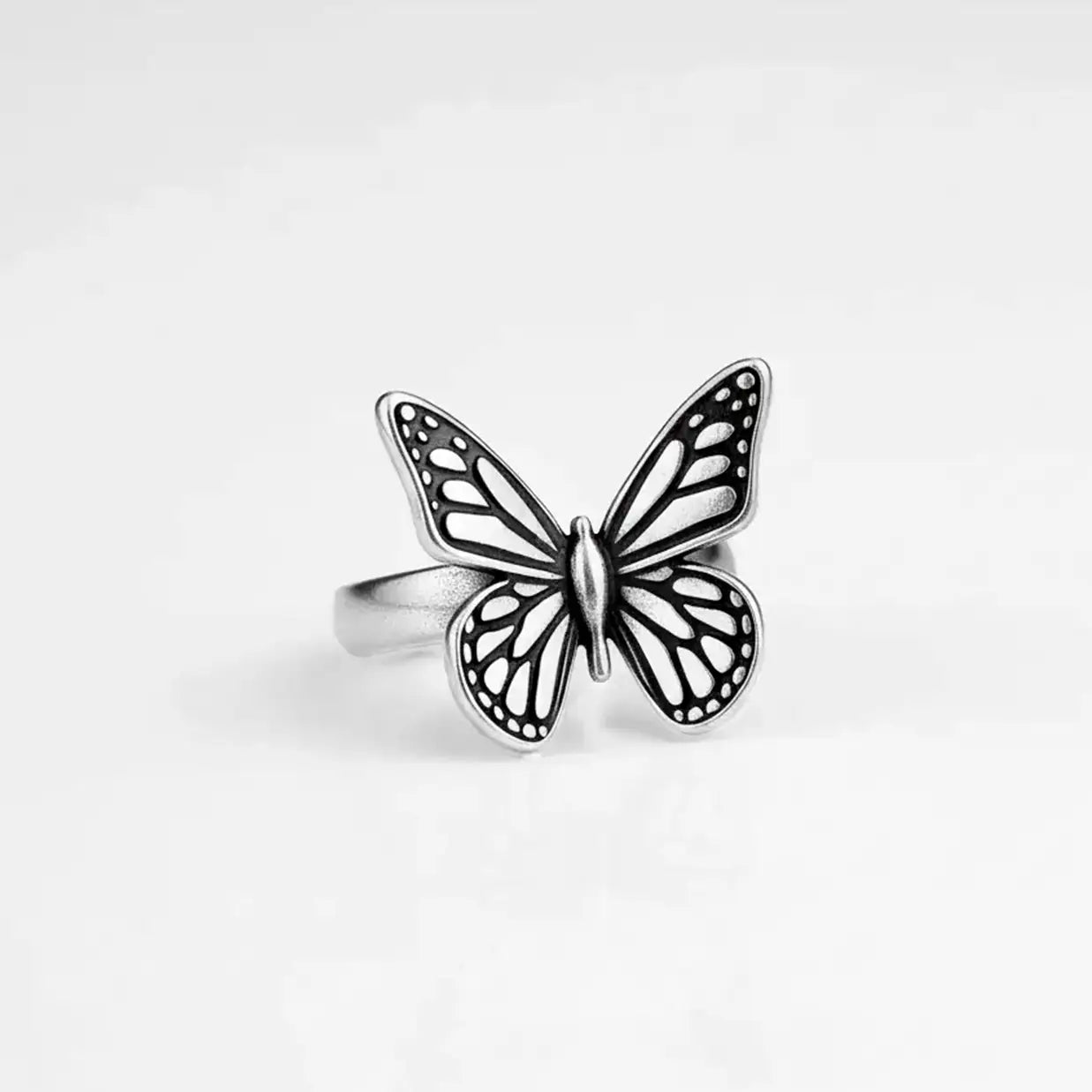 Silver monarch butterfly ring on a black background
