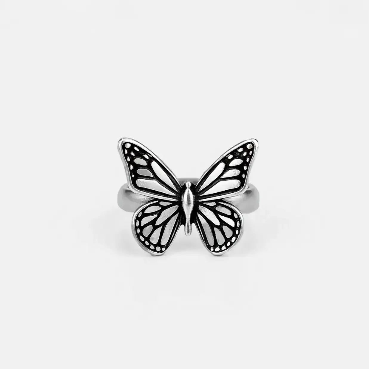 Silver monarch butterfly ring on a black background