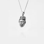 Silver pendant shaped like a MAYAN FACE on a white background